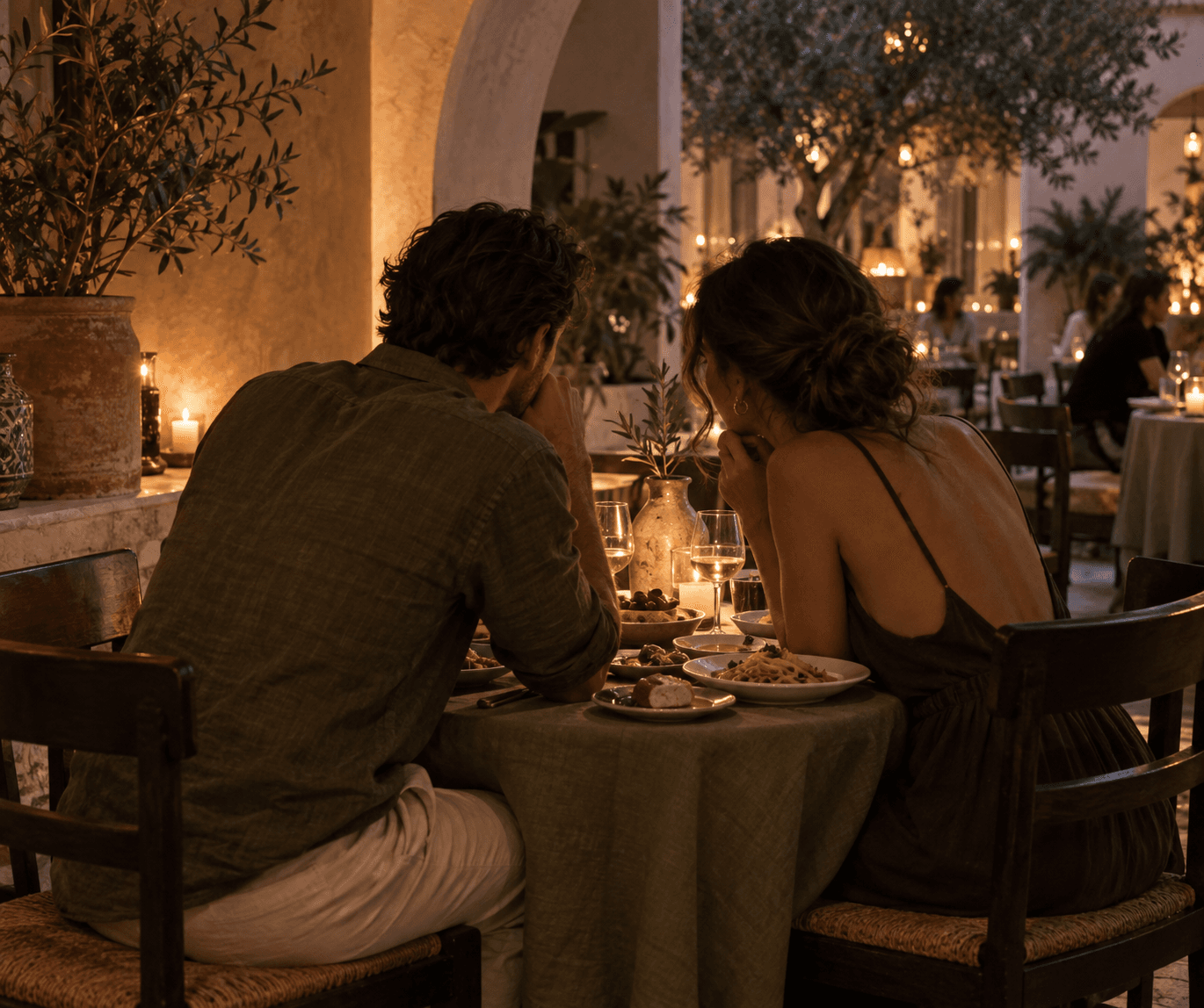 Couple sharing a candlelit dinner in Mediterra's courtyard